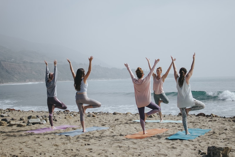 Group yoga on the beach — wellness class by the water
